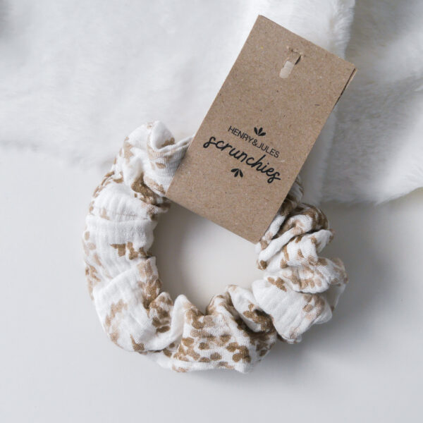 Handgemachtes Haargummi, sogenanntes Scrunchie, aus Stoff in weiß mit beigem Muster